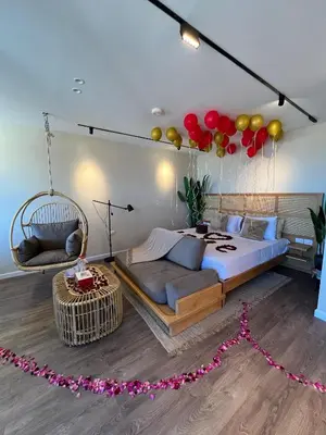 a bedroom with a swing bed and balloons on the wall at Suite 69 in Hurghada
