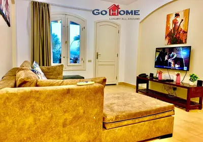 a living room with a couch and a tv at 1 Bed Room West Golf at El-Gouna Y12-0 in Hurghada