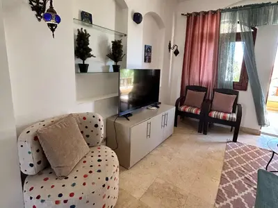 a living room with a couch and a flat screen tv at Hurghada Concierge in EL-Gouna in Hurghada
