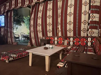 a living room with a table and a couch and a wall at Apartment - Sleeps 4 - Pool - Pet friendly in Hurghada