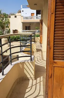 a balcony with stairs and a railing and a building at Villa Belzoni in Luxor