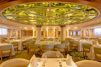 a restaurant with white tables and chairs and a large ceiling at Sonesta St George Nile Cruise - Luxor to Aswan 4 Nights from Monday to Friday in Luxor