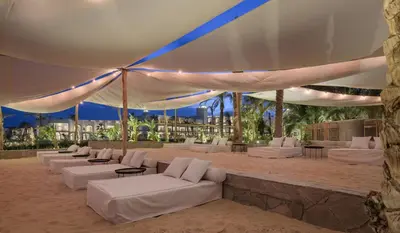 a group of white couches sitting under a tent at Serry Beach Resort in Hurghada