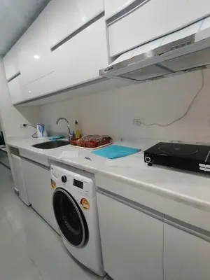 a kitchen with a washing machine and a sink at Scandic Resort in Hurghada