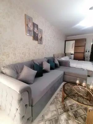 a living room with a couch and a bed at Scandic Resort in Hurghada