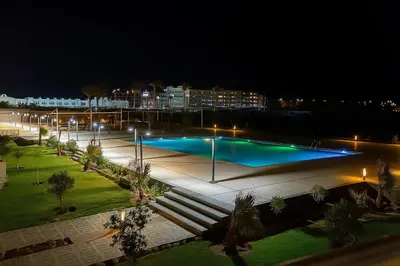 a large swimming pool at night with lights at Scandic Resort in Hurghada, EGYPT in Hurghada
