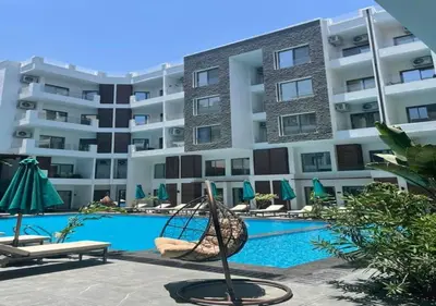 a large apartment building with a swimming pool at 3BR 2BA Retreat with Four Pools Gym and Onsite Dining Close to El Gouna in Hurghada