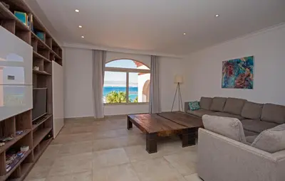 a living room with a couch and a table at Soma Bay Seafront Luxury Appartement in Hurghada