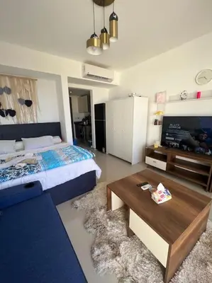 a bedroom with a bed and a coffee table at Brand new studio at G-Cribs ElGouna in Hurghada