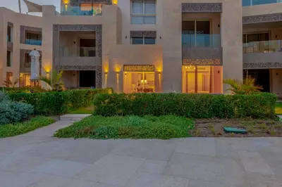 a large building with a walkway in front of it at Cozy 1-Bedroom Apartment in Mangroovy, El Gouna. Private terrace, garden and pool access in Hurghada