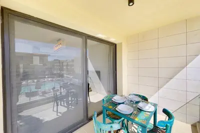 a blue table and chairs in a room with a patio at Refreshed & Uplifted 2 BDR G Cribs in Hurghada