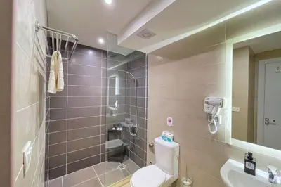 a bathroom with a shower and a toilet and a sink at Refreshed & Uplifted 2 BDR G Cribs in Hurghada
