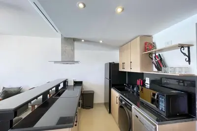a kitchen with black appliances and a black counter top at Refreshed & Uplifted 2 BDR G Cribs in Hurghada