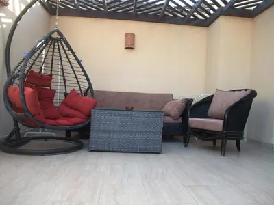 a hanging couch and two chairs in a room at Aldau heights Kevin in Hurghada