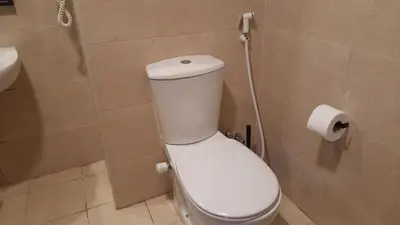 a bathroom with a toilet and a roll of toilet paper at Aldau heights Kevin in Hurghada