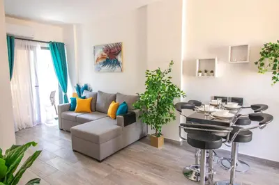 a living room with a couch and a table at 2 Bed Resort Apt-Sleeps 4-Balcony-Hotel Services in Hurghada