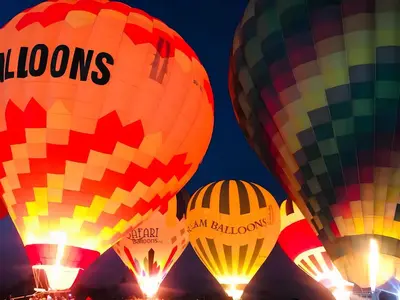 a group of hot air balloons in the sky at Royal Home Luxor Pool View in Luxor