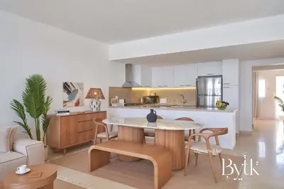 a kitchen and living room with a table and chairs at BYTK - La Veranda in Hurghada