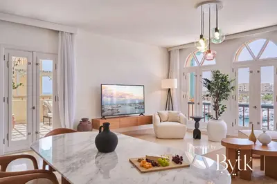a living room with a table and a tv at BYTK - La Veranda in Hurghada