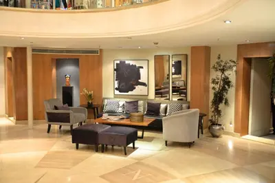 a living room with a couch and a table and chairs at Nile Cruise Aswan & Luxor & Abu Simbel in Luxor
