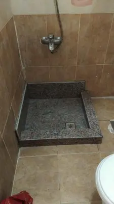 a bathroom with a shower with a tile floor at Moubark 6 Directly to the swimming pool in Hurghada