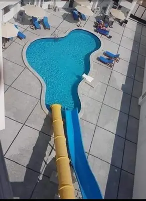 an overhead view of a water slide in a pool at ستوديو كومباوند طيبة فيو in Hurghada