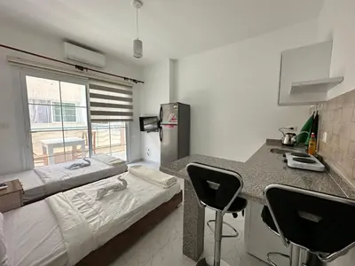 a room with a kitchen with a bed and a counter at Уютное место рядом с променадом in Hurghada