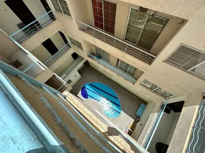 an aerial view of a building with a swimming pool at Уютное место рядом с променадом in Hurghada