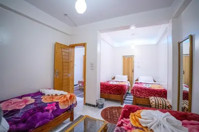 a bedroom with two beds and a mirror at Venus Hotel Luxor \u65e5\u672c\u4eba \u5927\u6b53\u8fce in Luxor