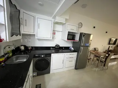 a kitchen with a refrigerator and a sink and a dishwasher at Palma Resort Hurgáda,8P4J22Q, Hurgada Palma Resort, apartment K75, Al Ismaileya, in Hurghada