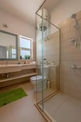 a bathroom with a glass shower and a toilet at Peaceful 2-Bedroom in Waterside, El Gouna. Pool & Lagoon in Hurghada