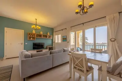 a living room with a couch and a table at Peaceful 2-Bedroom in Waterside, El Gouna. Pool & Lagoon in Hurghada