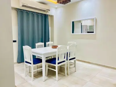 a dining room with a white table and chairs at Hurghada-Magawish Villa 1 in Hurghada