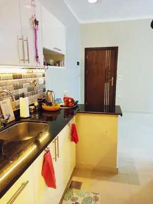 a kitchen with a sink and a counter top at WestLuxApartment in Al Karnak