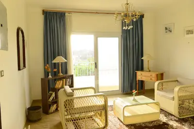 a living room with a couch and chairs and a window at Flamingo Boutique hotels in Luxor