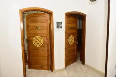 a hallway with two wooden doors in a room at Flamingo Boutique hotels in Luxor