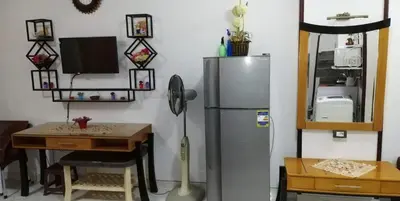 a kitchen with a stainless steel refrigerator and a table at منتجع طيبة فيو Tiba view in Hurghada