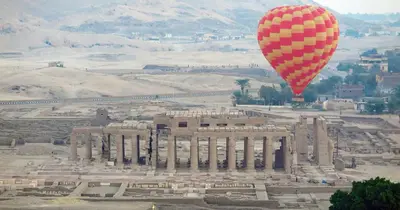 a hot air balloon flying over a building at Royal Home Luxor Nile View in Luxor
