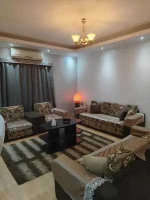 a living room with couches and a table at Amwaj Compound in Hurghada