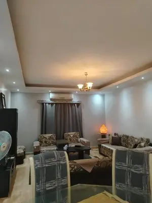 a living room with a couch and chairs and a ceiling at Amwaj Compound in Hurghada