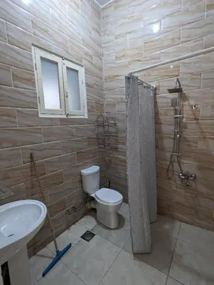 a bathroom with a toilet and a sink at Villa Rebecca in Luxor