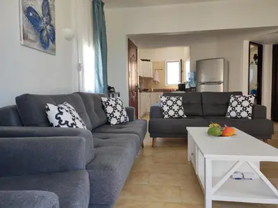 a living room with two couches and a table at Chalet Stella Makadi Beach 5* in Hurghada