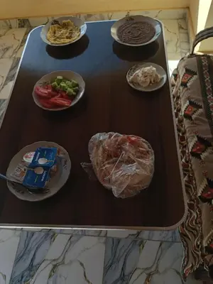 a table with plates of food on top at Hamo Fathy Nubian House in Aswan
