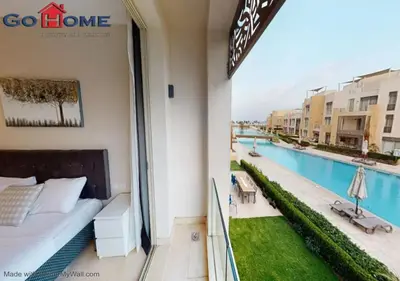 a balcony of a hotel with a bed and a swimming pool at Stylish 1BR-Pool View M7-6B at Mangroovy El-Gouna in Hurghada