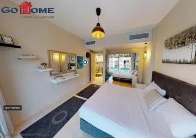 a bedroom with a large white bed and a couch at Stylish 1BR-Pool View M7-6B at Mangroovy El-Gouna in Hurghada