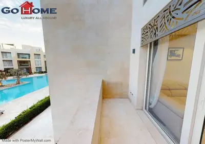 a room with a view of the pool in a building at Stylish 1BR-Pool View M7-6B at Mangroovy El-Gouna in Hurghada