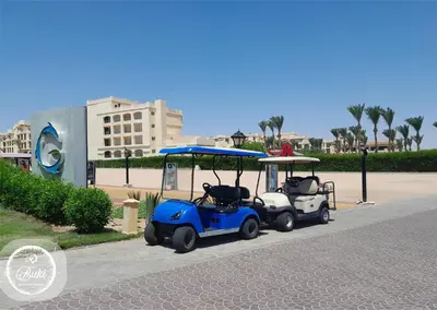 a golf cart parked on the side of a road at Sea View at Gravity Sahl Hasheesh 7 Pools & Beach-FOR GUESTS WITH NONEGYPTIAN PASSPORTS in Hurghada