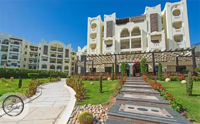 a large building with a garden in front of it at Sea View at Gravity Sahl Hasheesh 7 Pools & Beach-FOR GUESTS WITH NONEGYPTIAN PASSPORTS in Hurghada