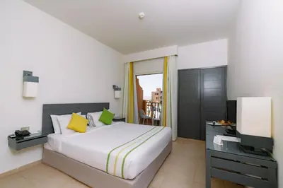 a hotel room with a bed and a television at Lemon & Soul Makadi Garden in Hurghada