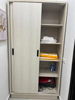 a closet with a white door and shelves at Benashti Hurghada apartment in Hurghada